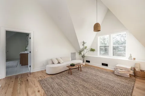 a view of a room with wooden floor