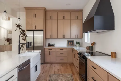 a kitchen with granite countertop cabinets and white appliances