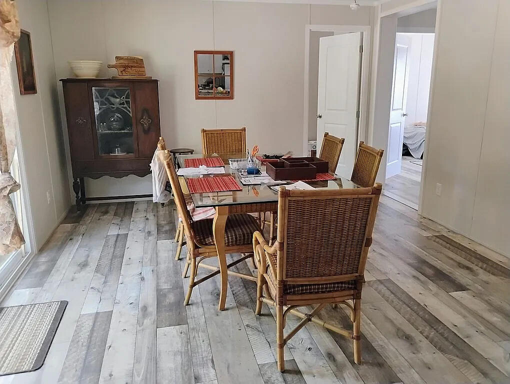 650 Satellite Road Graceville, FL 32440 - Photo 12 of 23 a view of a dining room with furniture window and wooden floor
