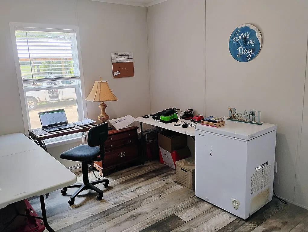 650 Satellite Road Graceville, FL 32440 - Photo 16 of 23 a room with a table chairs and a workspace