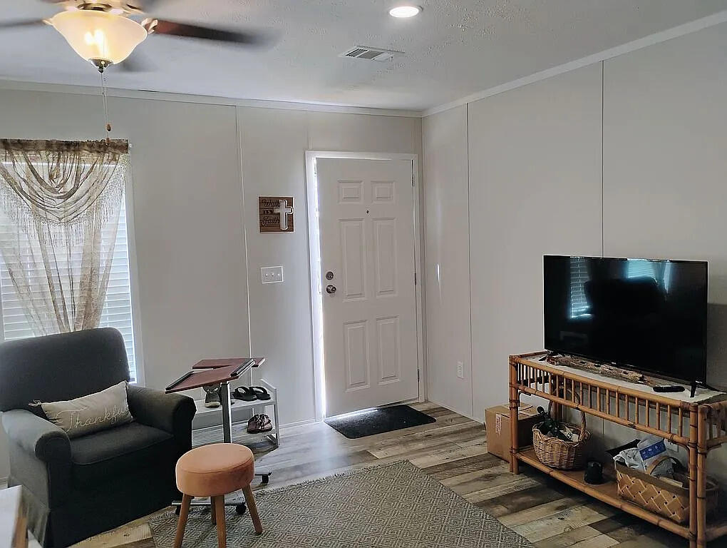 650 Satellite Road Graceville, FL 32440 - Photo 7 of 23 a living room with furniture and a flat screen tv