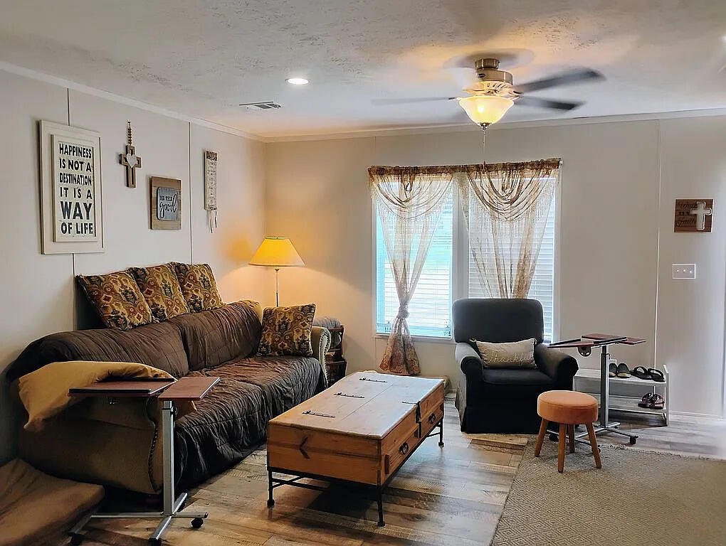 650 Satellite Road Graceville, FL 32440 - Photo 8 of 23 a living room with furniture two lamps and a large window