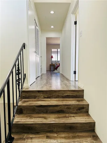 a kitchen with stainless steel appliances granite countertop a dining table chairs and granite counter tops