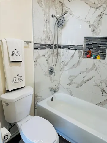 a bathroom with a toilet sink and shower