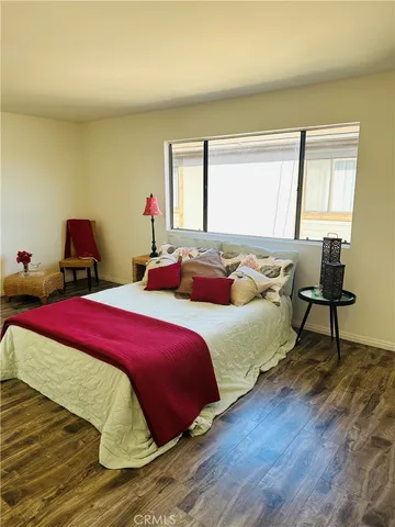 a bedroom with bed and a window