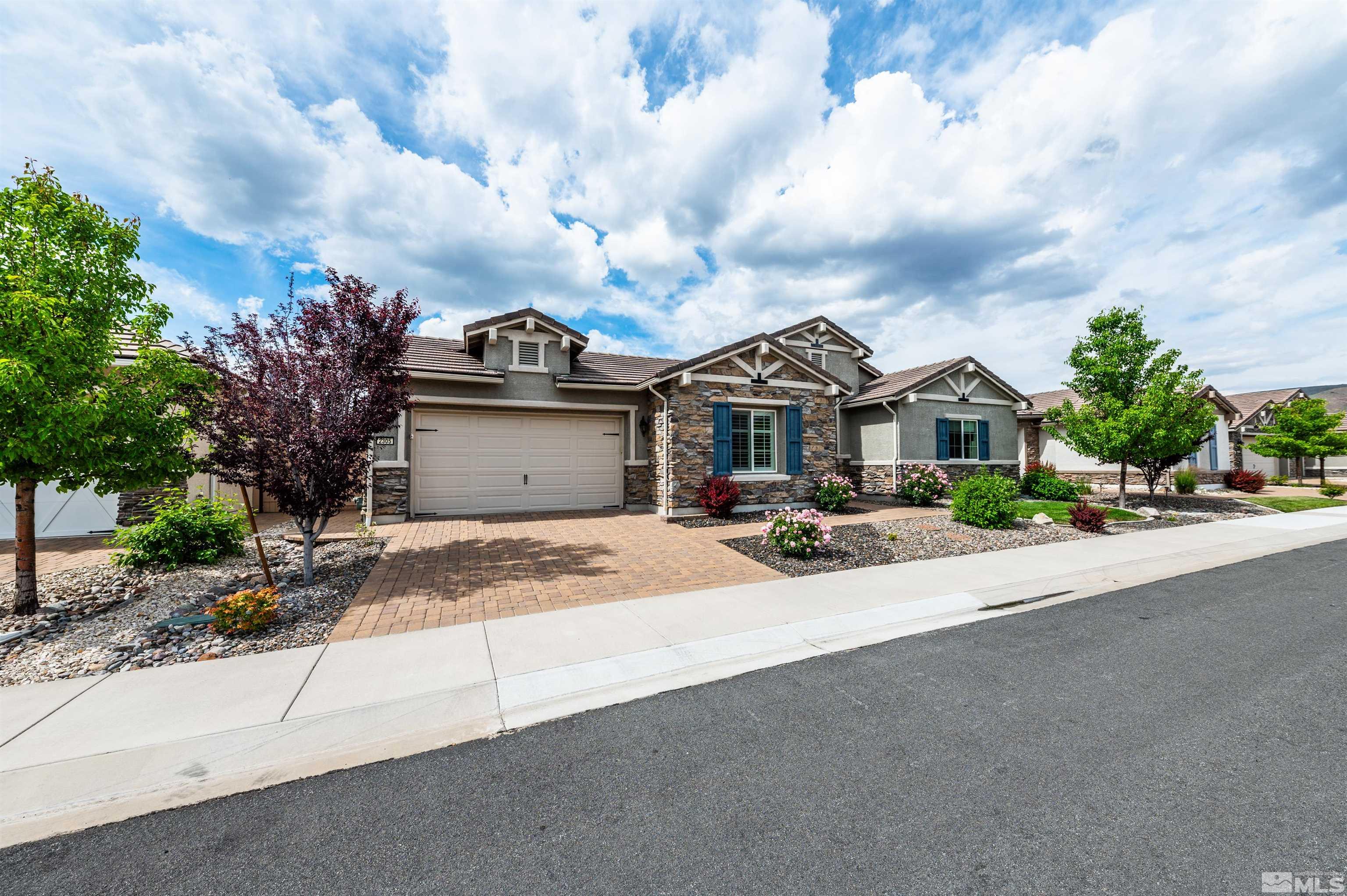 2305 Trakehner Lane Reno, NV 89521 - Photo 1 of 40 a front view of a house with a yard and garage
