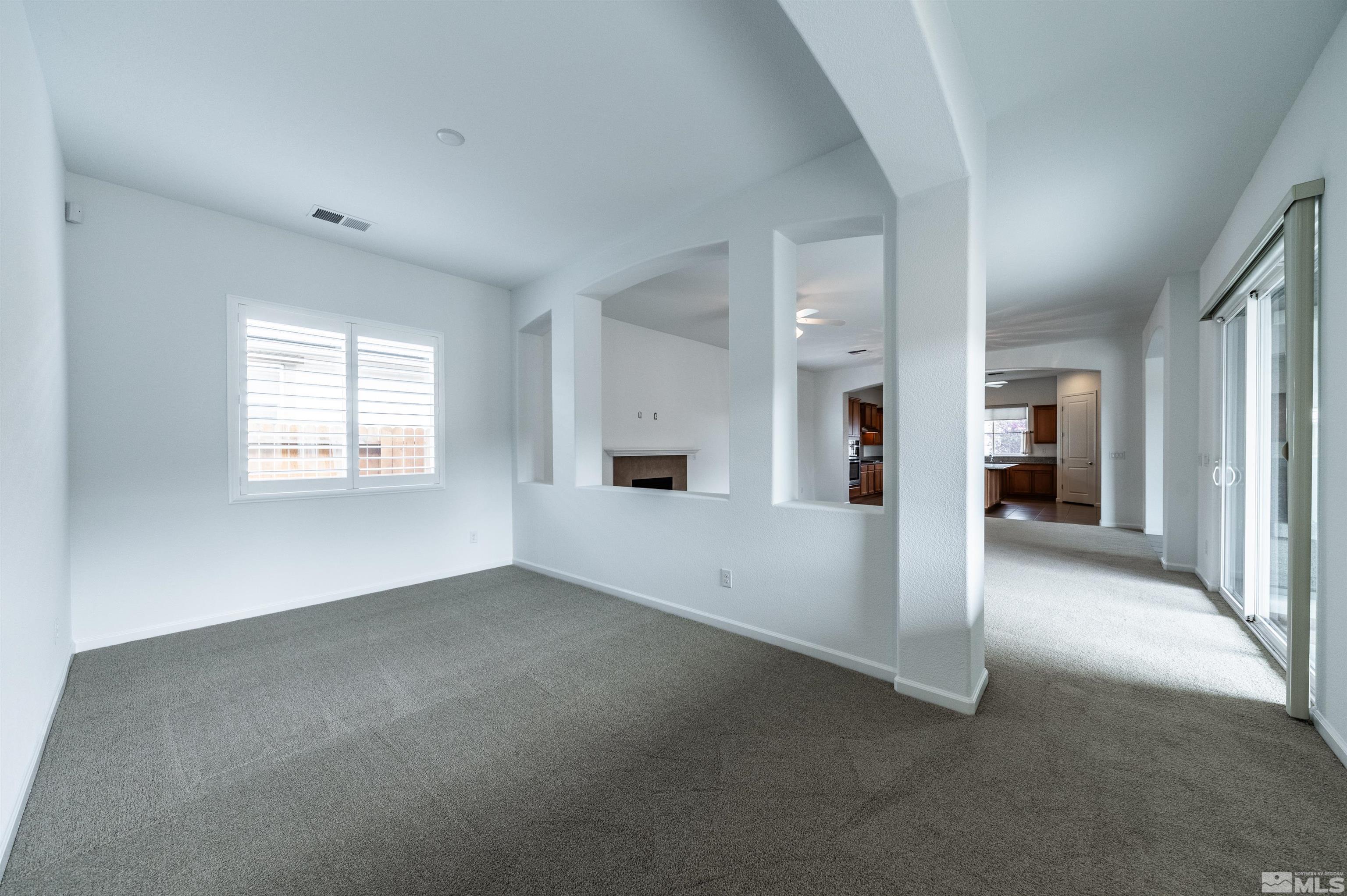 2305 Trakehner Lane Reno, NV 89521 - Photo 11 of 40 a view of a big room with windows and chandelier