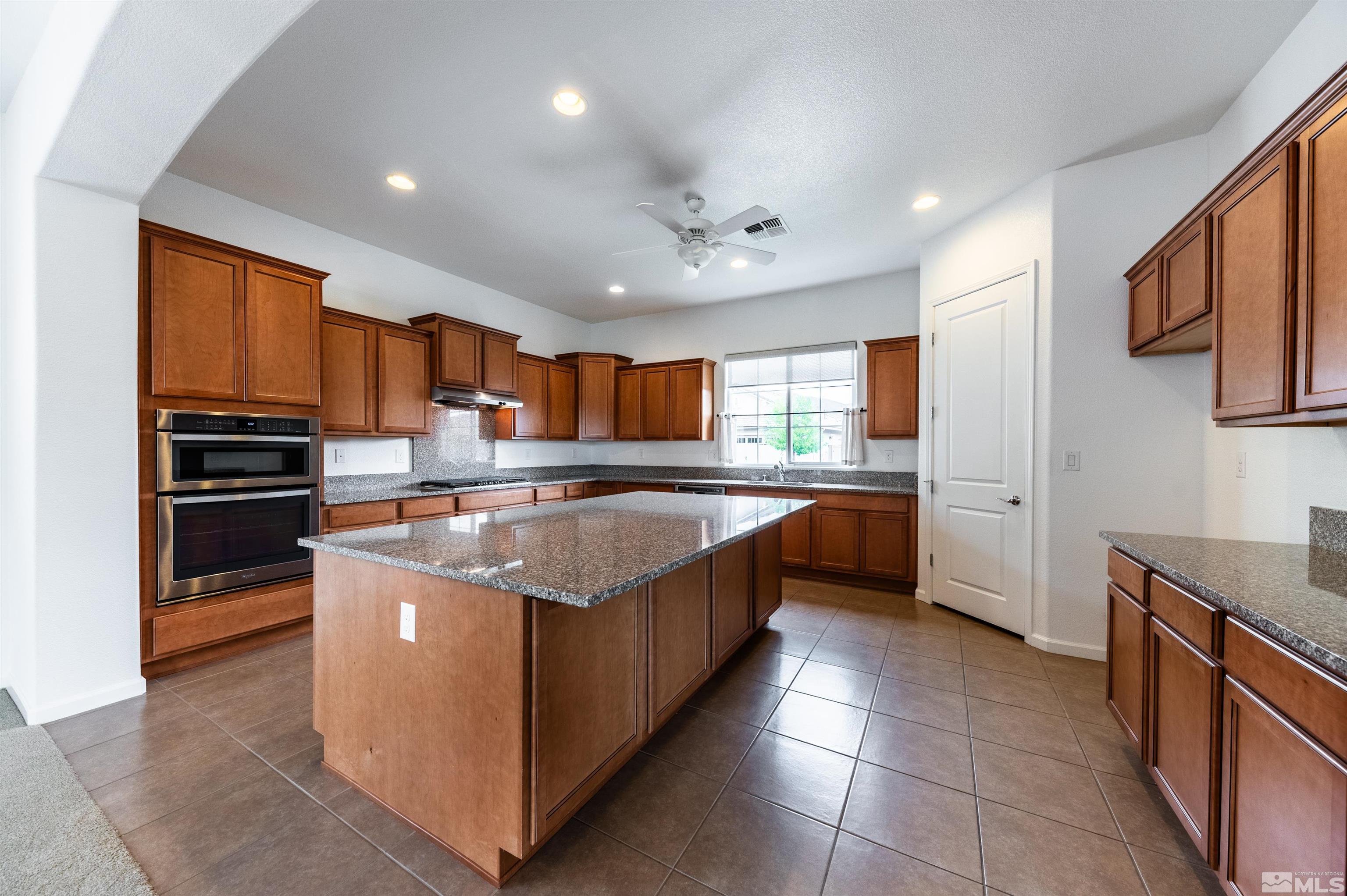 2305 Trakehner Lane Reno, NV 89521 - Photo 12 of 40 a large kitchen with stainless steel appliances granite countertop a large counter top and a stove