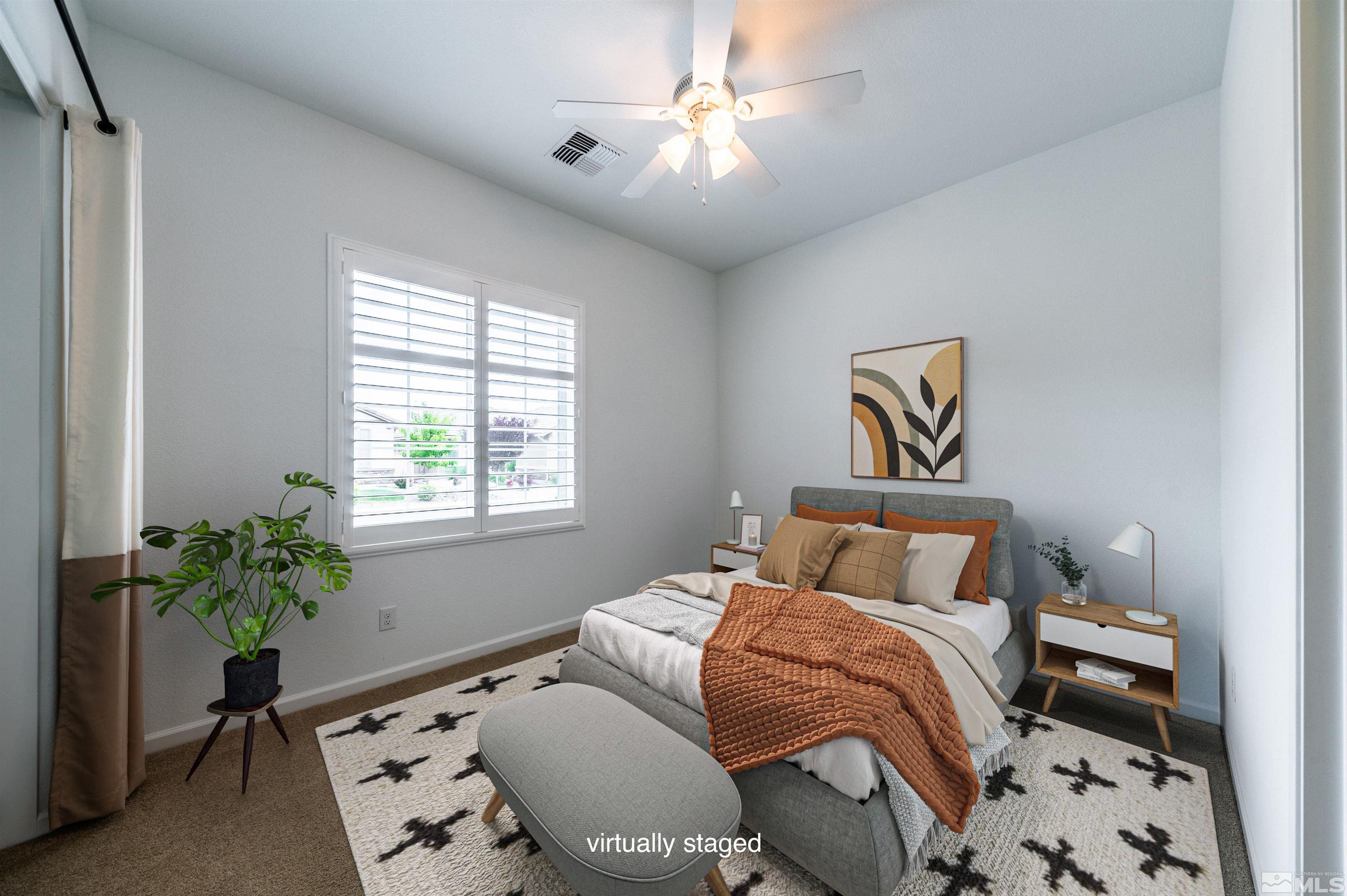 2305 Trakehner Lane Reno, NV 89521 - Photo 19 of 40 a bedroom with a bed and a potted plant