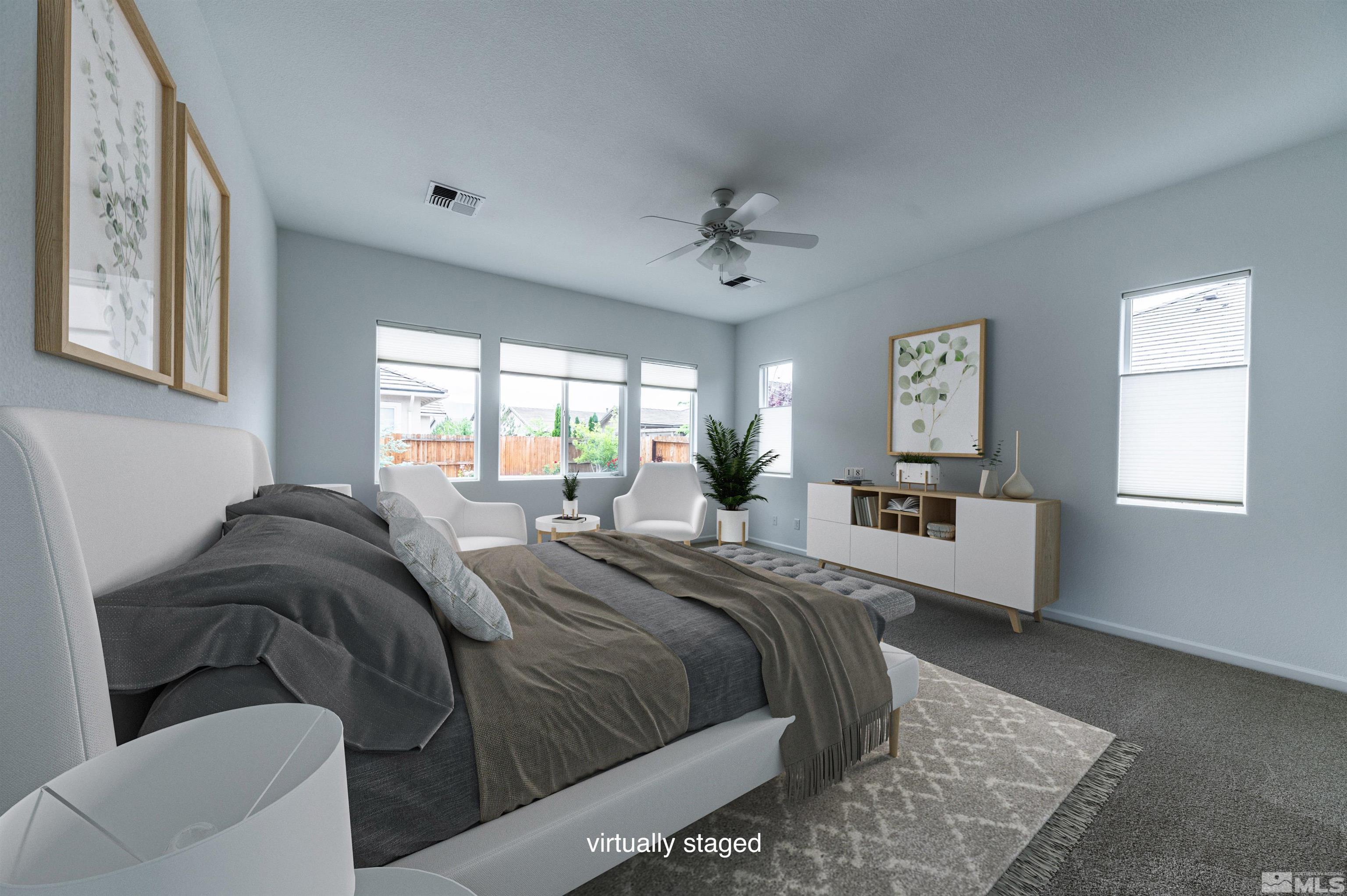 2305 Trakehner Lane Reno, NV 89521 - Photo 21 of 40 a bedroom with a bed and a chandelier