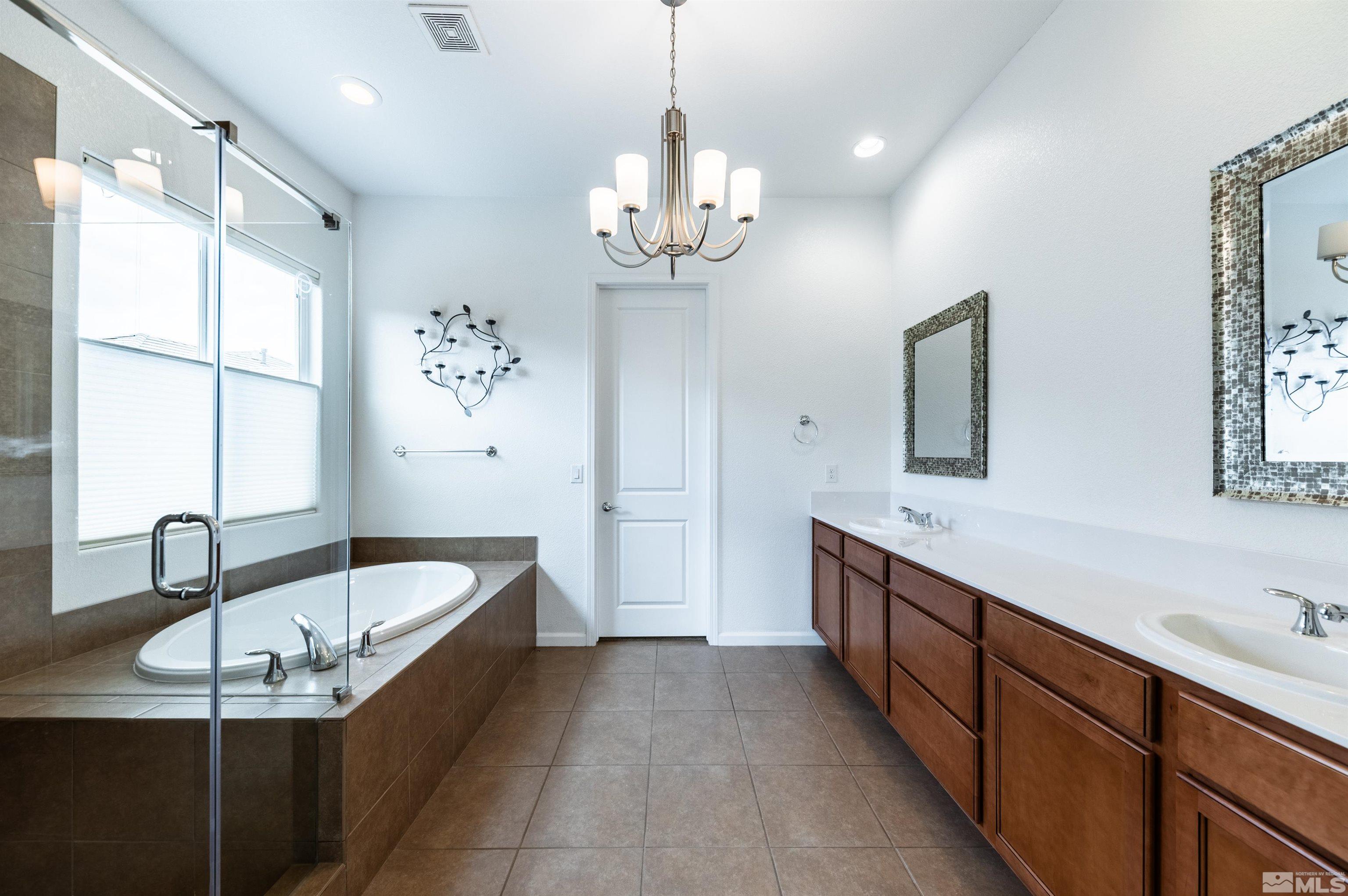 2305 Trakehner Lane Reno, NV 89521 - Photo 23 of 40 a bathroom with a tub sink and mirror
