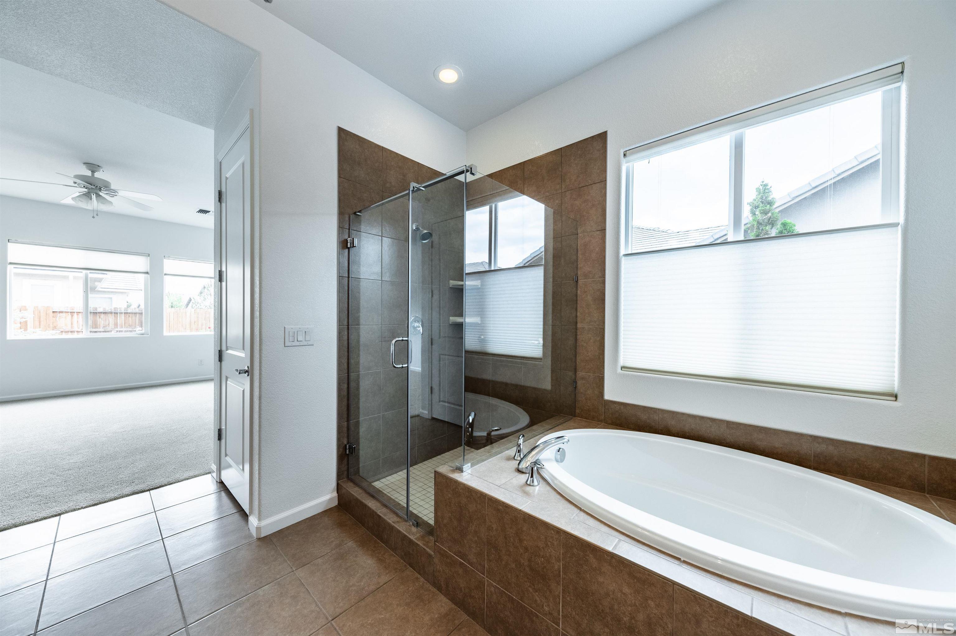 2305 Trakehner Lane Reno, NV 89521 - Photo 24 of 40 a bathroom with a bathtub and a shower