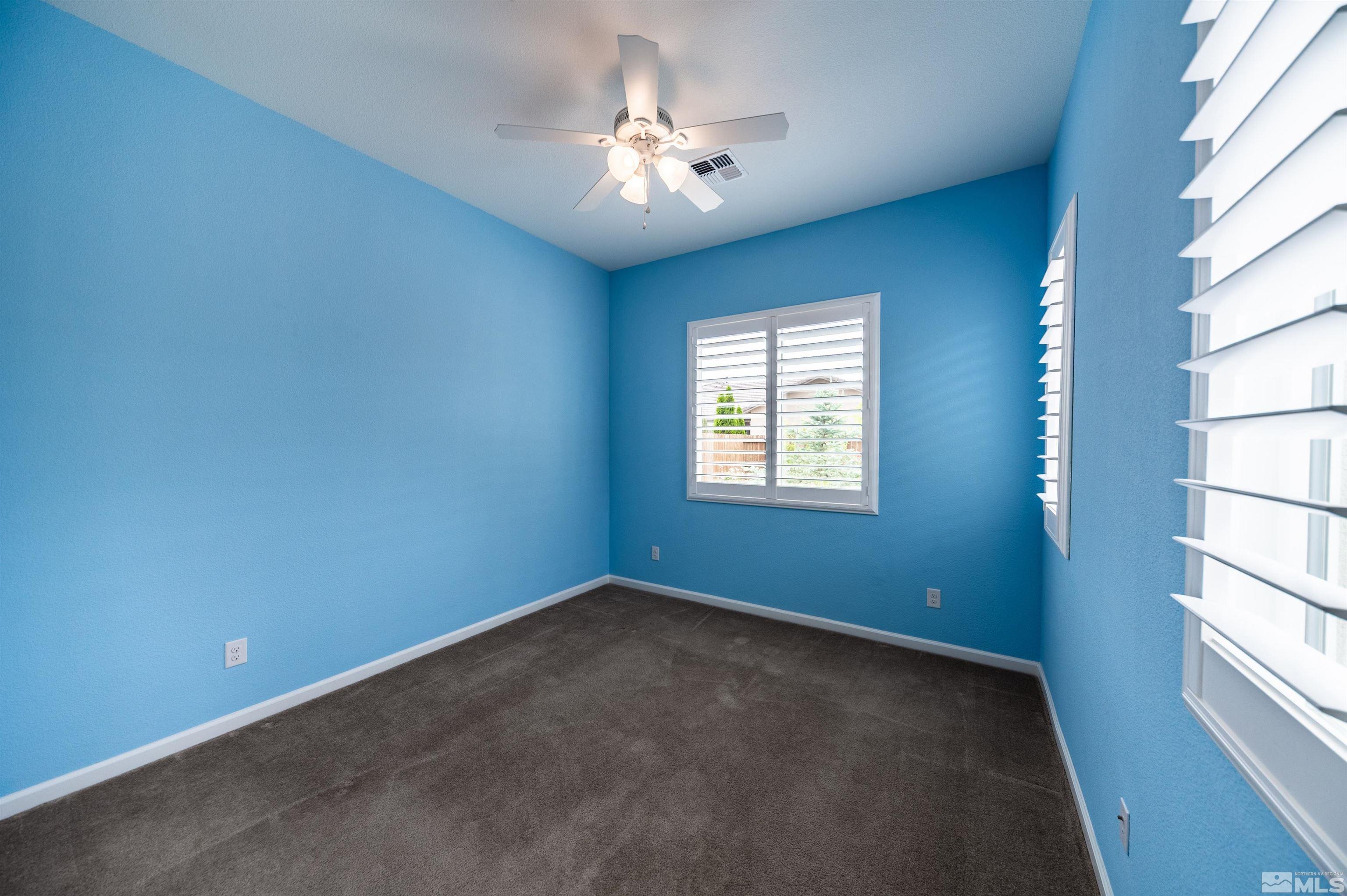2305 Trakehner Lane Reno, NV 89521 - Photo 30 of 40 an empty room with windows and fan