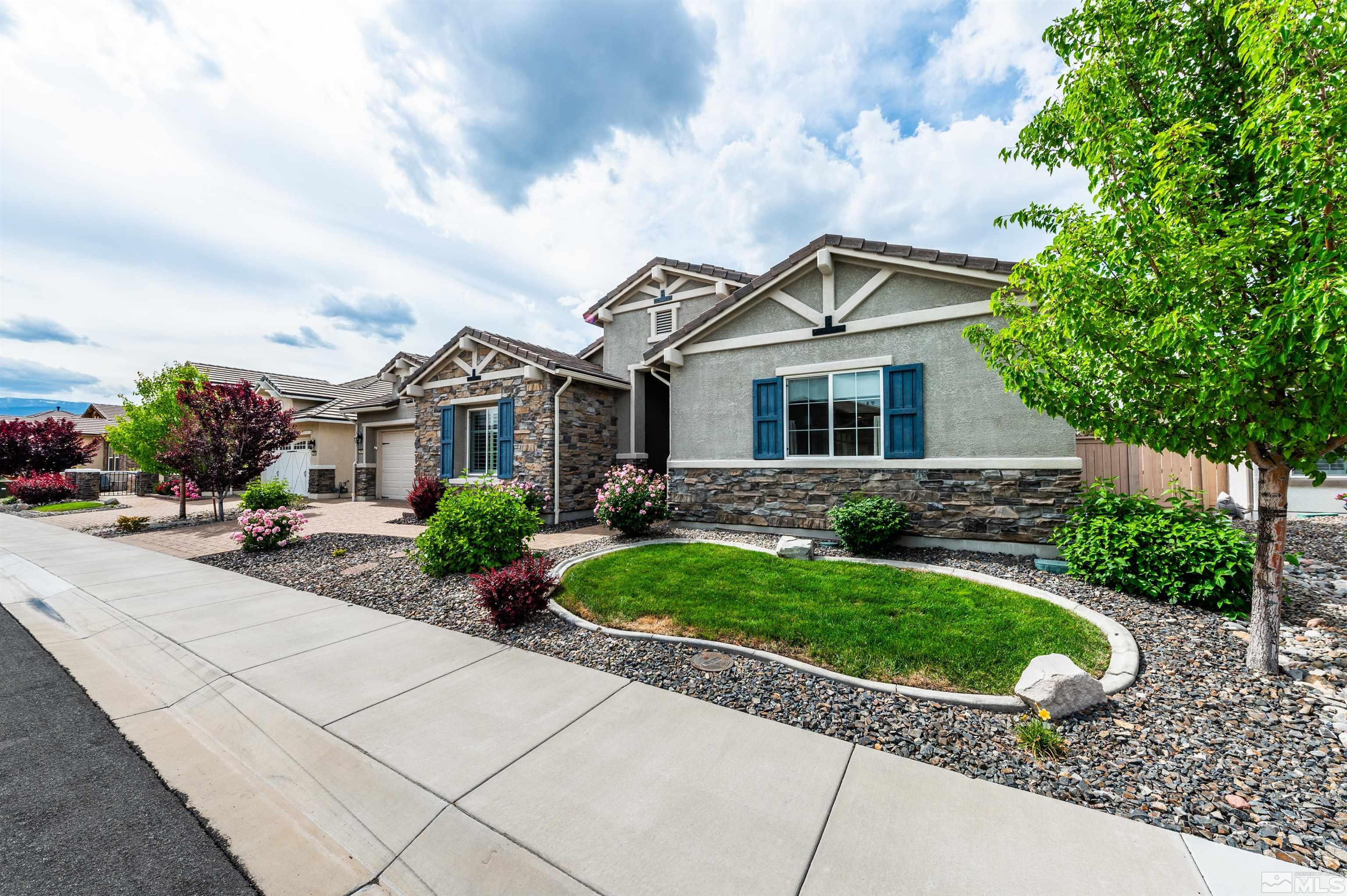 2305 Trakehner Lane Reno, NV 89521 - Photo 3 of 40 a front view of a house with a garden and plants