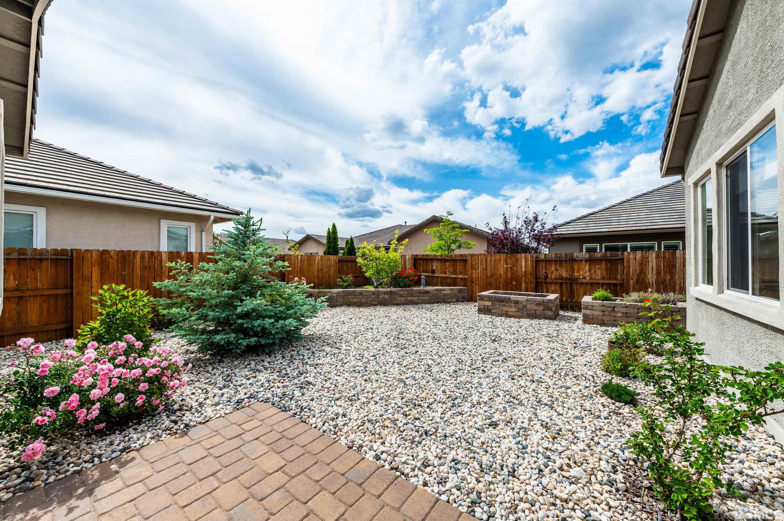 2305 Trakehner Lane Reno, NV 89521 - Photo 31 of 40 a front view of a house with a yard and a garden