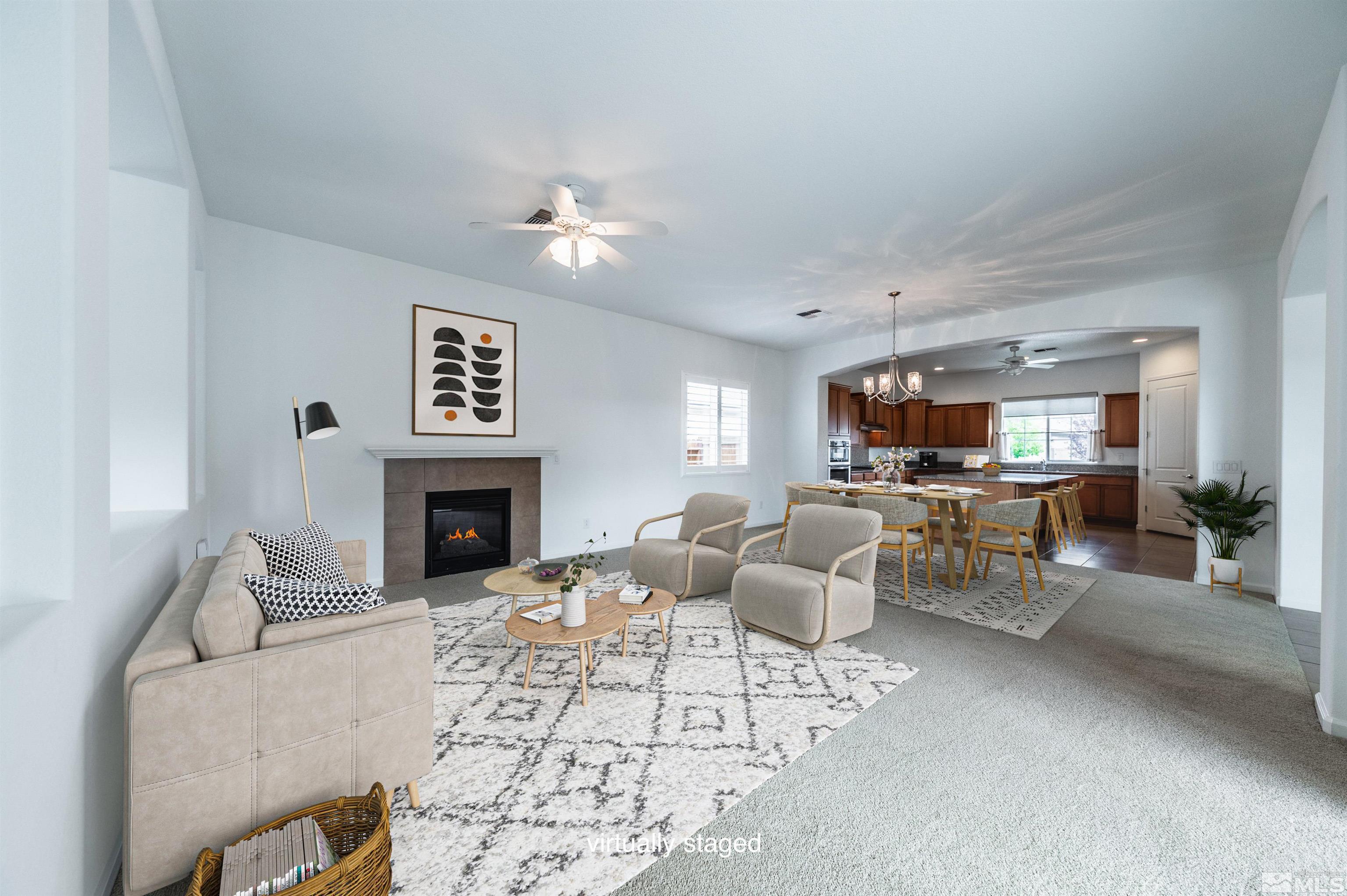 2305 Trakehner Lane Reno, NV 89521 - Photo 8 of 40 a living room with furniture a fireplace and a table