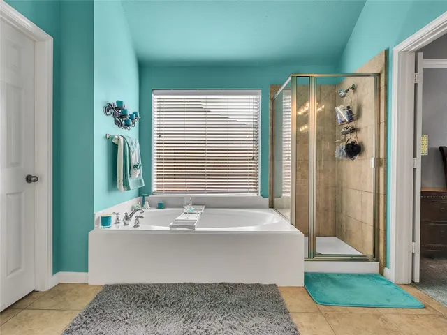 an aerial view of a house with a yard and lake view