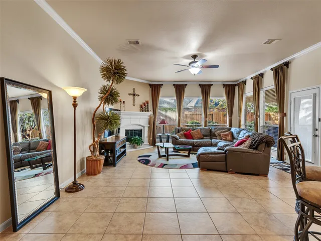 a kitchen with stainless steel appliances granite countertop a stove top oven a refrigerator a sink and chairs