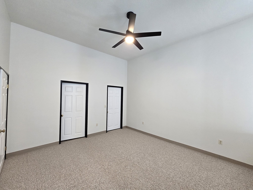 147 Rawson Road, Unit G3 Quincy, MA 02170 - Photo 13 of 20 an empty room with chandelier fan