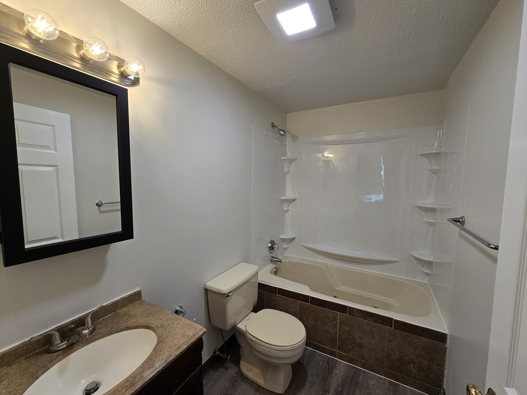 147 Rawson Road, Unit G3 Quincy, MA 02170 - Photo 15 of 20 a bathroom with a granite countertop sink toilet and shower