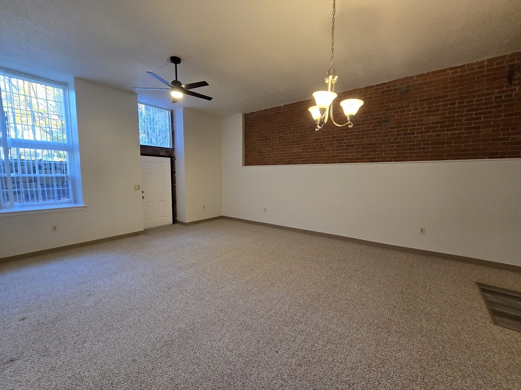 147 Rawson Road, Unit G3 Quincy, MA 02170 - Photo 6 of 20 a view of a chandelier fan and windows in a room