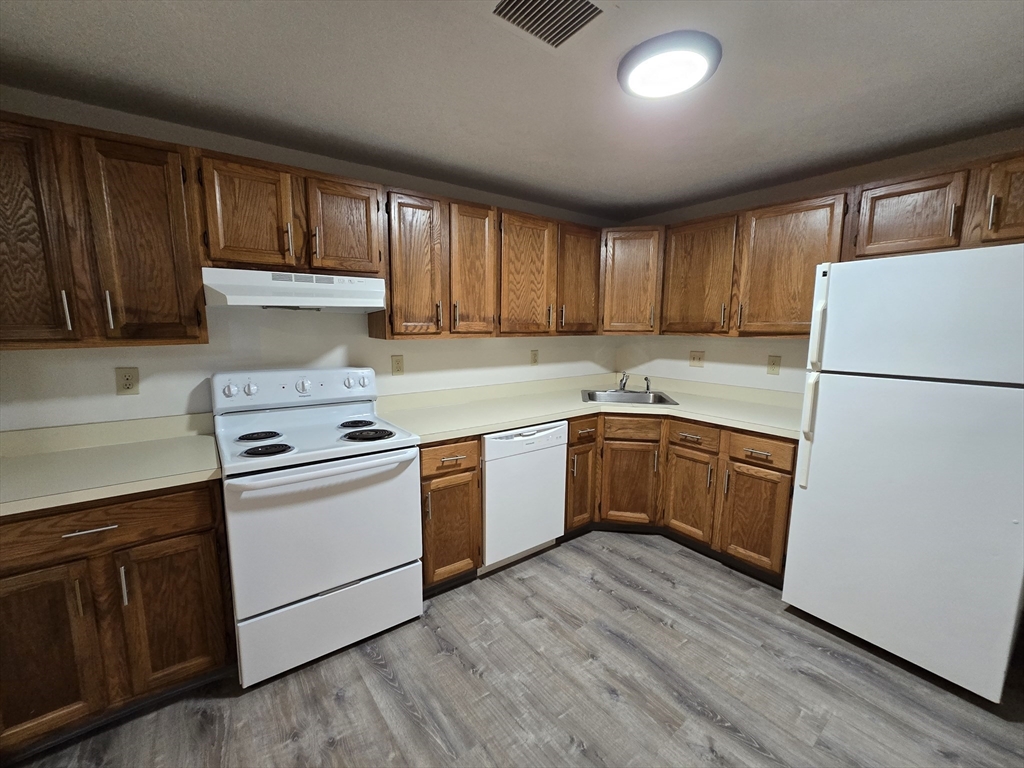 147 Rawson Road, Unit G3 Quincy, MA 02170 - Photo 7 of 20 a kitchen with a white cabinets and white appliances