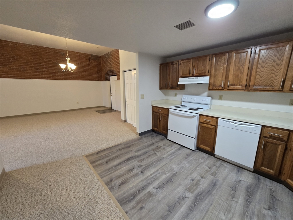 147 Rawson Road, Unit G3 Quincy, MA 02170 - Photo 8 of 20 a kitchen with stainless steel appliances granite countertop a stove a sink and a refrigerator