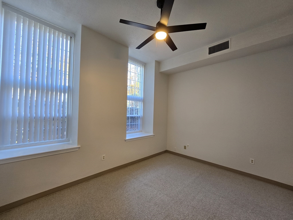 147 Rawson Road, Unit G3 Quincy, MA 02170 - Photo 10 of 20 an empty room with a window and a fan