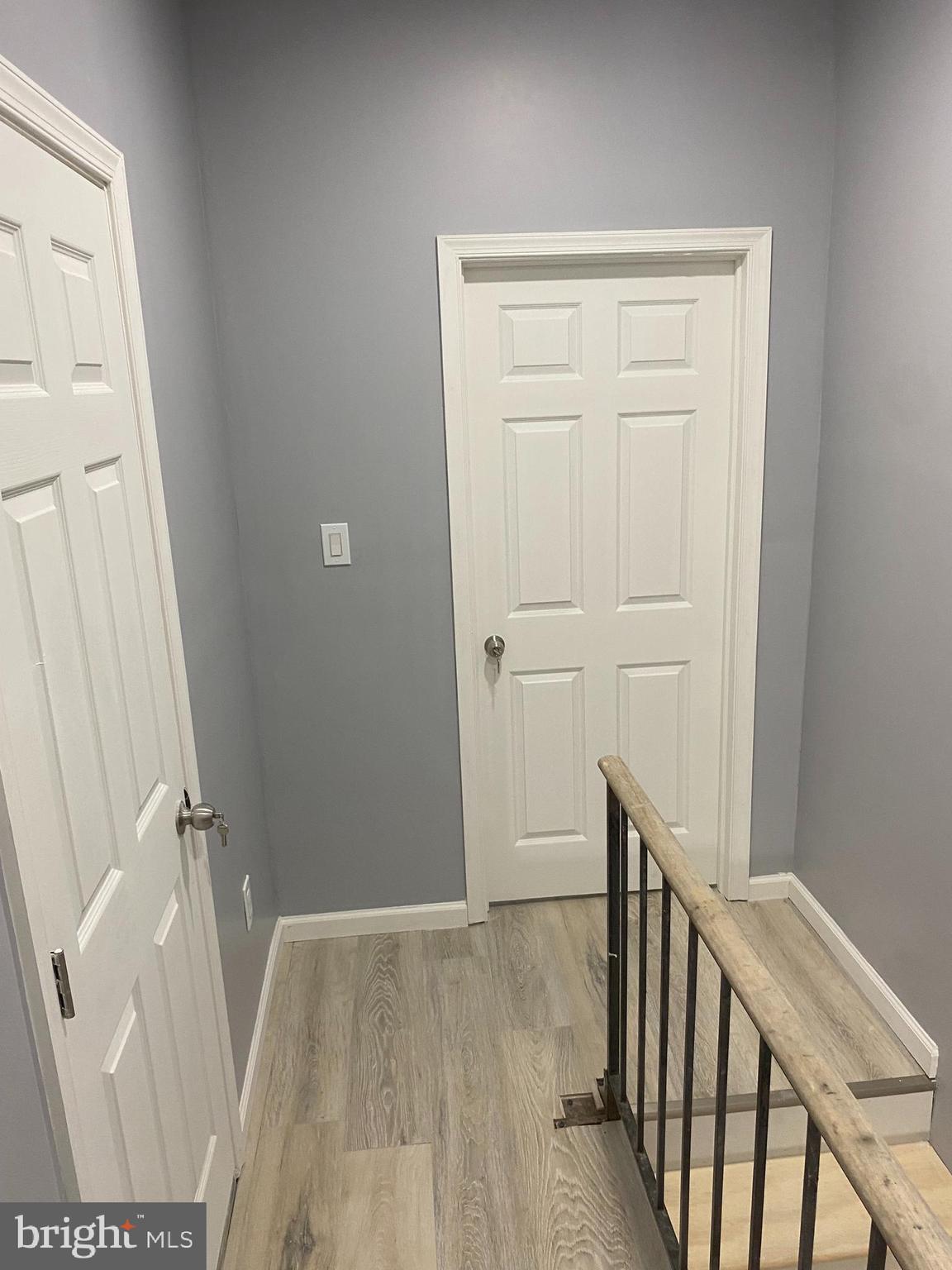 1820 Hope Street Baltimore, MD 21202 - Photo 14 of 14 a view of a hallway with wooden floor and staircase