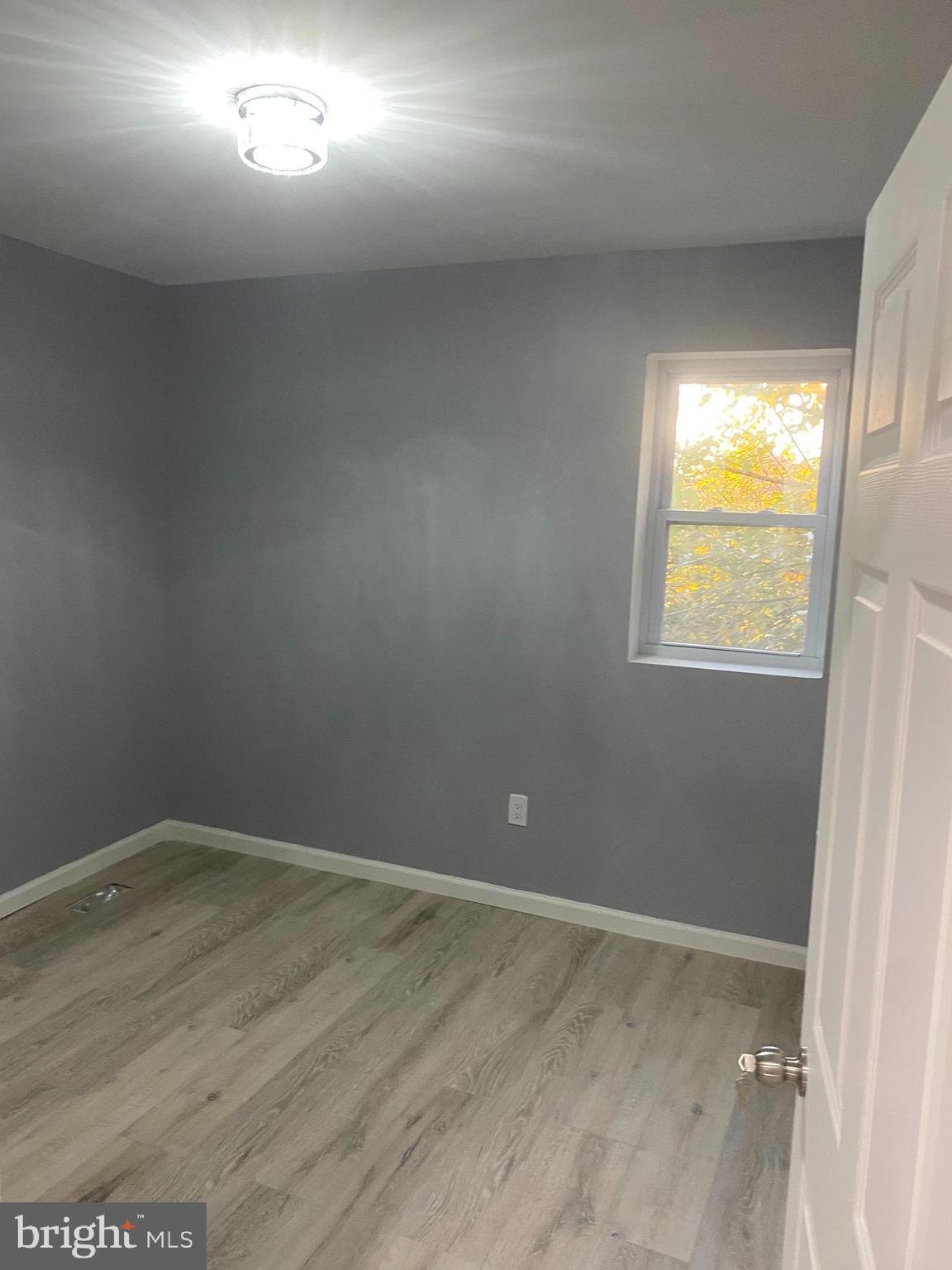 1820 Hope Street Baltimore, MD 21202 - Photo 5 of 14 an empty room with a window