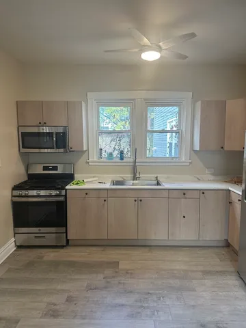 a kitchen with stainless steel appliances granite countertop a stove and a sink