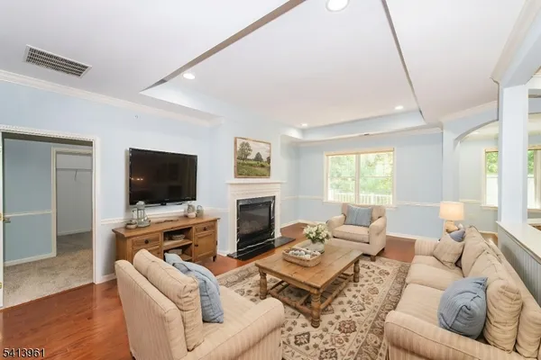 a living room with furniture a flat screen tv and a large window