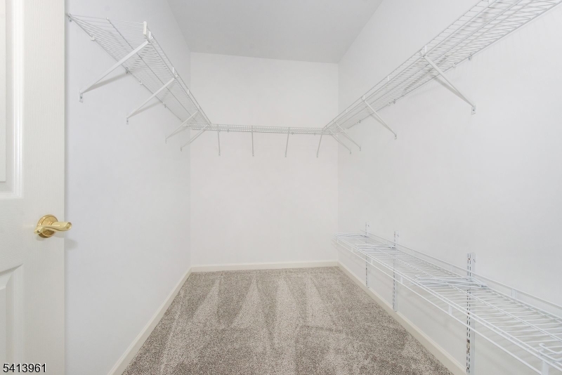 29 Ridgeview Lane, Unit 29 Mount Arlington, NJ 07856 - Photo 11 of 17 a view of a room with racks on the wall