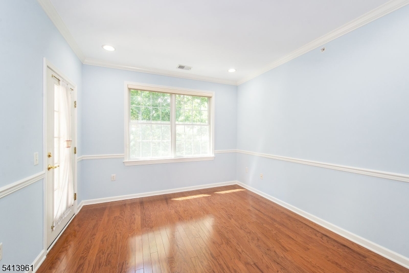 29 Ridgeview Lane, Unit 29 Mount Arlington, NJ 07856 - Photo 4 of 17 an empty room with wooden floor and windows
