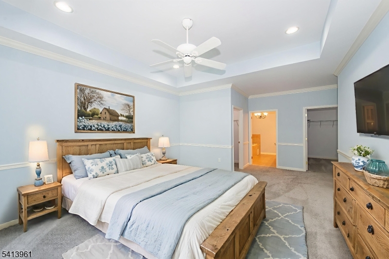 29 Ridgeview Lane, Unit 29 Mount Arlington, NJ 07856 - Photo 7 of 17 a bedroom with a bed and a flat screen tv