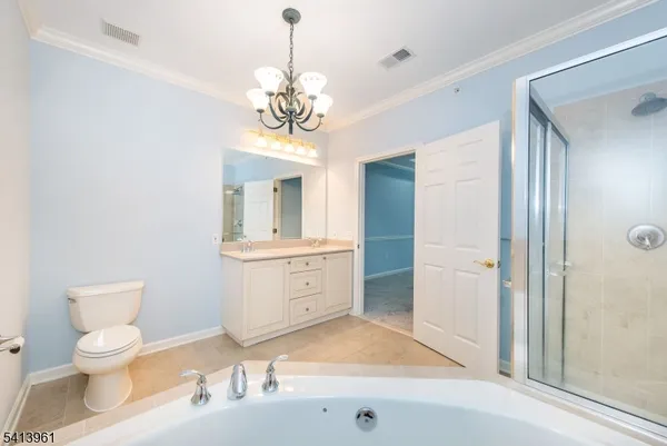 a spacious bathroom with a toilet a sink and mirror