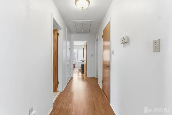 a view of a hallway with wooden floor