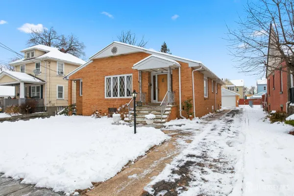 a view of a house with snow on the road