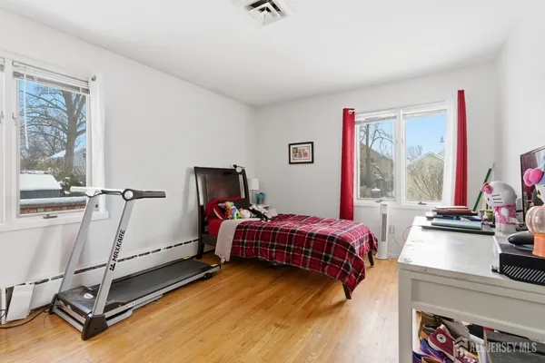 a bedroom with furniture and a window