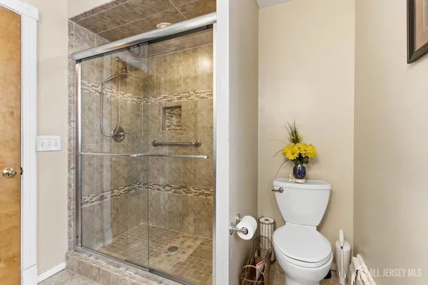 a white toilet sitting next to a bathroom sink