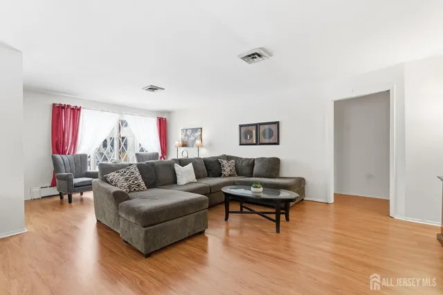a kitchen with stainless steel appliances a dining table chairs and white cabinets