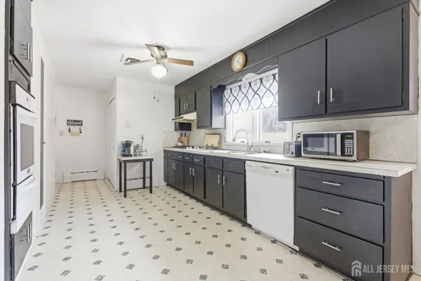 a kitchen with a sink cabinets and window