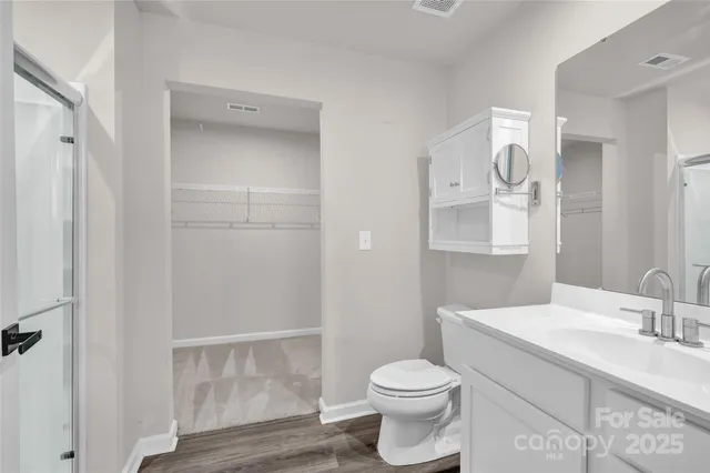 a bathroom with a glass shower door