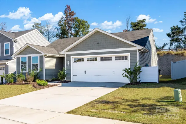 a front view of a house with a yard and a garage