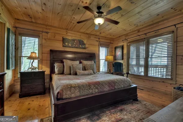 a bed sitting in a bedroom next to a window