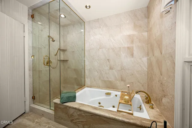 a bathroom with a granite countertop sink and a large mirror next to a window
