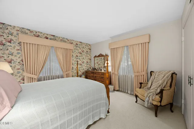 a bathroom with a granite countertop sink and a large mirror