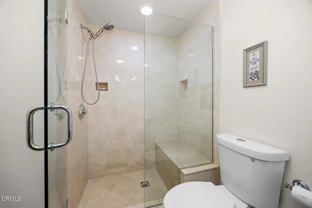 a view of a backyard with large trees and plants