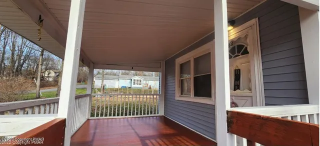 a view of a porch with wooden floor and outdoor space