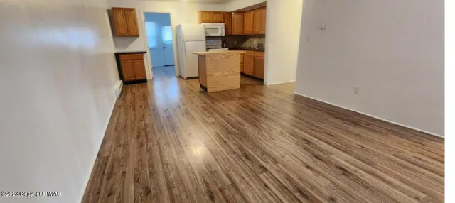 a view of a kitchen from the hallway